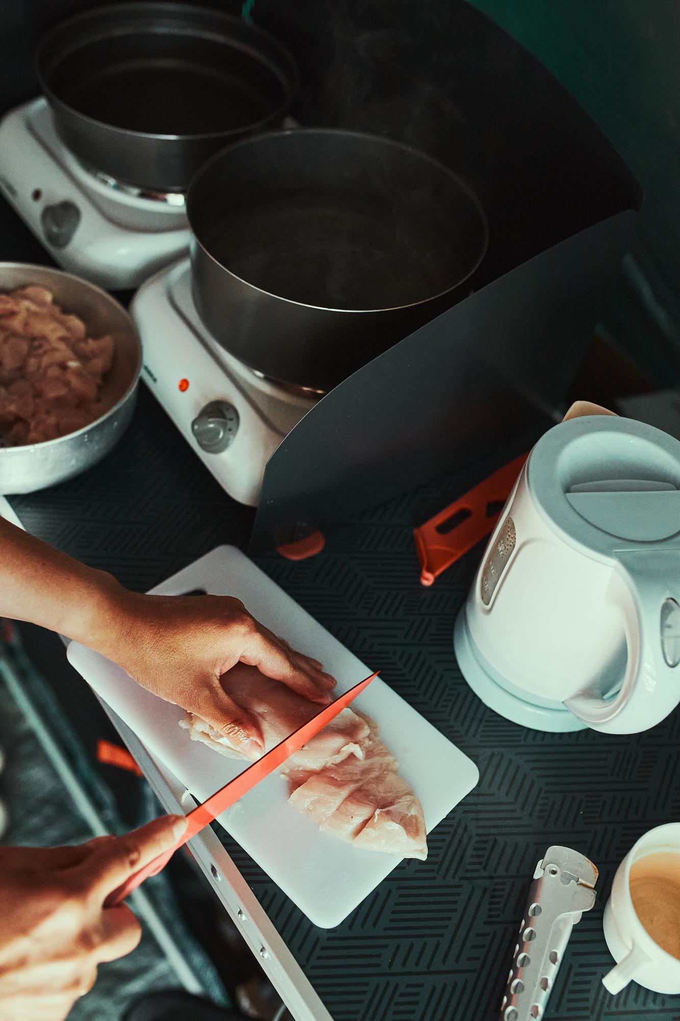 Chef assembling a meal kit with modern tools